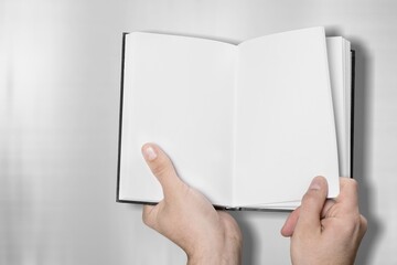 Person hands with blank book on desk