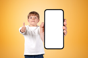 Boy wearing casual wear holding smartphone case with copy space
