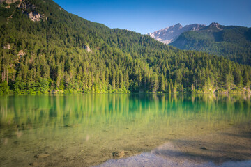 Lake Tovel reflection symmetry in Trentino-Alto Adige, Dolomites, Italy