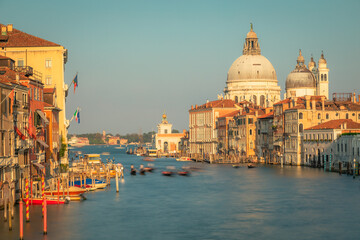Naklejka premium Blurred Gondole in grand canal at golden sunrise, Ethereal Venice, Italy