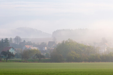 Fototapeta na wymiar Rural landscape at Ondrasova village shrouded in morning mist.