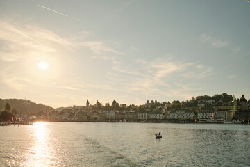 Fototapeta premium Sunlit lake with boat at sundown