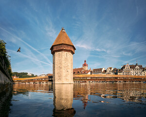Water Tower in Reuss river under blue sky in Switzerland