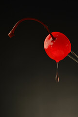 Maraschino cherry with goopy drip - obrazy, fototapety, plakaty
