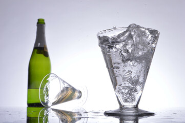 Glass of bubbling champagne and bottle