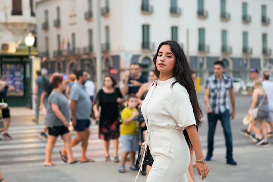 Business Latin Woman Looking At Camera Surrounded By People