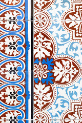 Detailed view of ornamental tile mosaic in browns and blues 