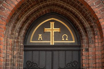 alpha and omega at the doorway to Graabrødre Klosterkirke in Odense