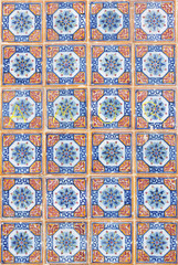 Squared tiles mosaic orange and blue with winter flower in the middle