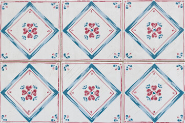 Decorative squared tile pink and blue with spring flowers in the center