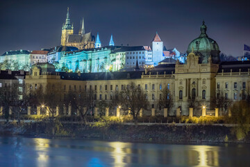 Fototapeta na wymiar Hradcany, St Vitus Cathedral and Vltava river at night with blurred boat, Prague