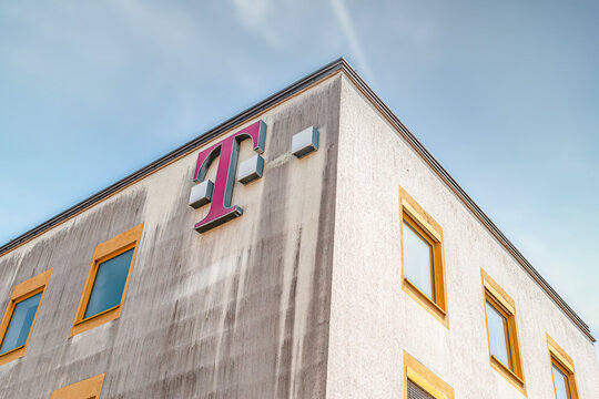 Schweinfurt, Bavaria, Germany, Jun 18th, 2022: Brand Logo of german telekom on an elderly building in front of a blue sky