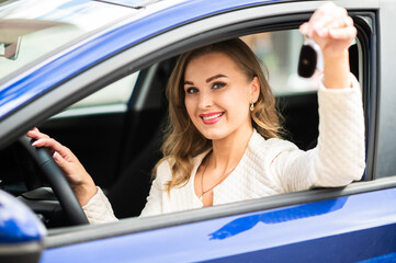 Young lady holding the keys of her new car