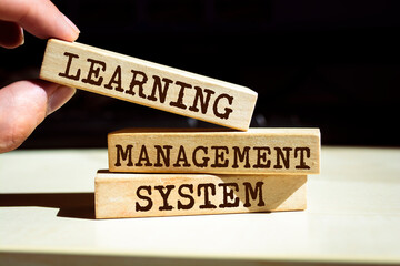 Wooden blocks with words 'Learning Management System'.