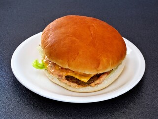 Tokyo,Japan - September 12, 2022: An isolated hamburger on a white plate
