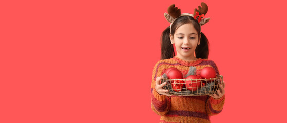 Funny little girl with Christmas decor on red background with space for text