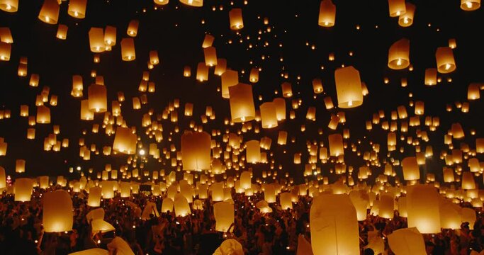 Amazing sky lanterns lifting up into the night sky, epic world travel and adventure, Fire Lanterns at the Yee Peng Festival in Chiang Mai Thailand, Shot on RED cinematic slow motion