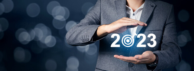 2023 and target icon on virtual screen.