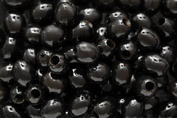 Heap of black olives as background, closeup