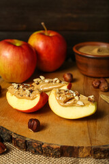 Naklejka na ściany i meble Wooden board of tasty apple wedges with nut butter, closeup