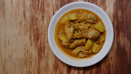 Gulai ayam dan kentang. Indonesian chicken curry with potato. Is traditional side dish from Minangkabau cuisine