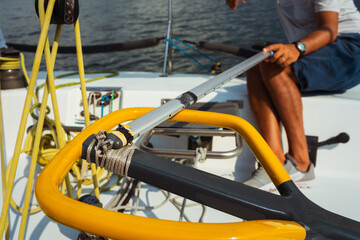 beginner courses for men on a sailing yacht. a man controls the steering wheel on a speedboat....