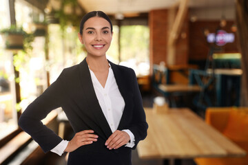 Portrait of hostess wearing uniform in cafe. Space for text