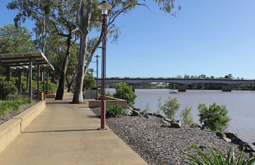 View of the Rockhampton waterfront with a path, Fitzroy River and bridge in Queensland, Australia