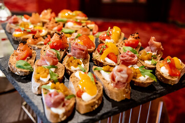 many different sandwiches with fish and vegetables on a granite stand