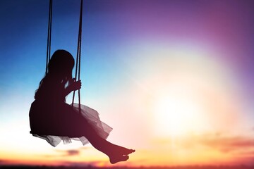 A girl swings by the sky view. Freedom concept.
