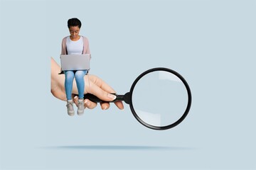 A woman with a laptop and big hand with magnifying glass.