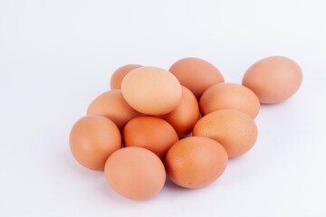 Several chicken eggs are placed on a white background...