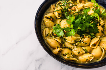 healthy plant-based food, vegan shell pasta with chickpeas and spinach in creamy sauce