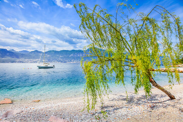 Idyllic lake Garda coastline in Malcesine with sailboats, Northern Italy