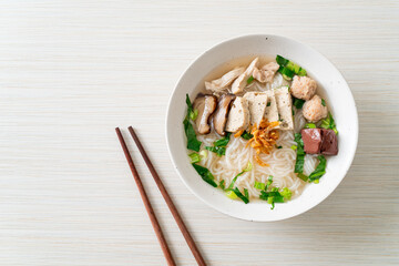 Vietnamese Rice Noodles Soup with Vietnamese Sausage served vegetables and crispy onion