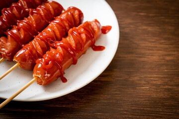 fried sausage skewer with ketchup