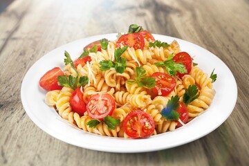 Italian pasta salad with cheese, tomato, mushroom and fresh vegetables.