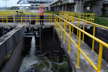 Wastewater treatment concept. Service engineer on  waste water Treatment plant and checking oxygen in water with tablet.