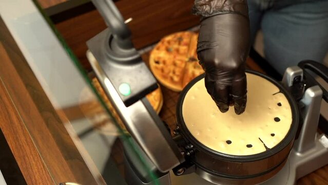 Adding preparing topping chocolate chips in to waffle maker oster gofrera slow motion