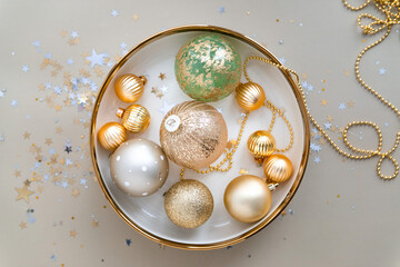 Mixed new year decorations in festive holiday dish top view