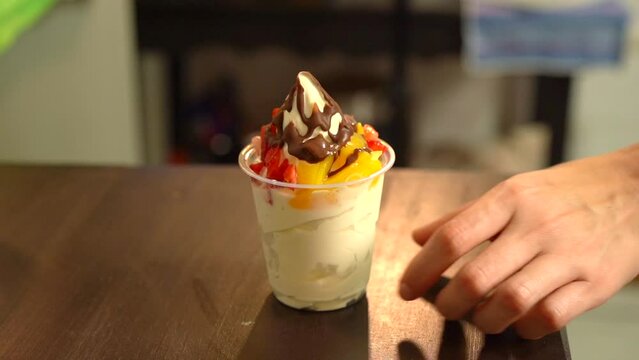 Hand lif take ice cream fruits natura chocolate in slow motion berries peach gold
