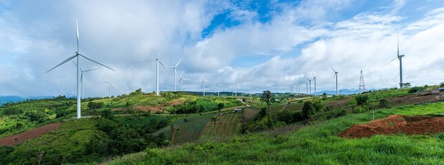 Landscape of Panorama wind turbines on hills with blue sky background. Renewable energy concept