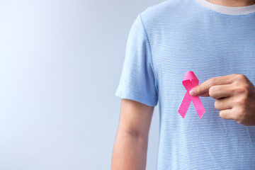 Pink October Breast Cancer Awareness month, man hold pink Ribbon for support people life and...