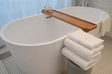 white bathroom with towels and bathtub