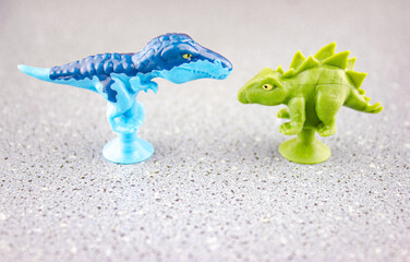 Blue and green dinosaur toys for children on the table.Plastic dinosaurs of the ancient era,epoch.