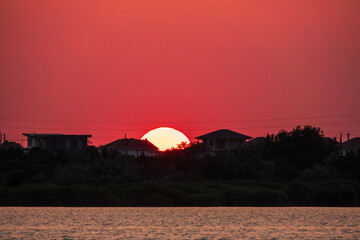 The sun goes down over a lake