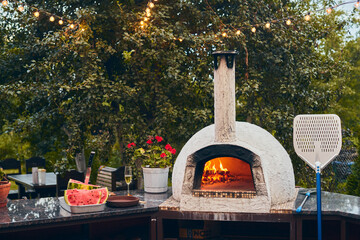 Wood-fired pizza oven with birch logs for kindling. The fire burns and the oven heats up. Front...