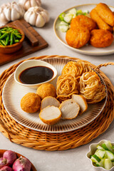 Pempek is a savoury Indonesian fishcake delicacy, made of fish and tapioca from Palembang. Pempek is served with sweet and sour sauce.