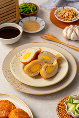 Pempek is a savoury Indonesian fishcake delicacy, made of fish and tapioca from Palembang. Pempek is served with sweet and sour sauce.