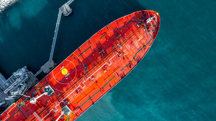 Aerial view oil ship tanker vessel loading and unloading in oil terminal station refinery, Global...